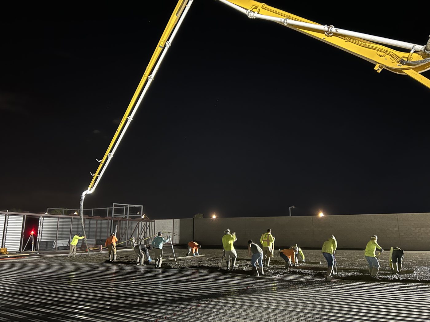 Hoyt Concrete crew finishing a night pour on a commercial slab